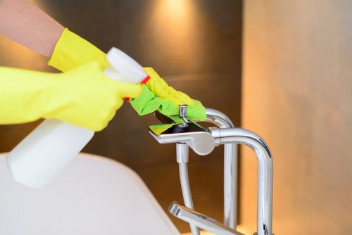 Local cleaner treating fabric stains on a living room sofa in E14