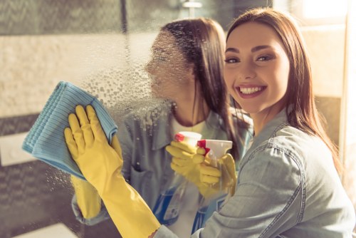 Professional steam cleaner restoring a hallway carpet in E14